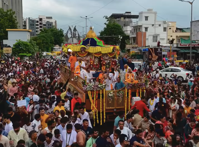 Devotees pulling Lord Jagannath's chariot during the ISKCON Rath Yatra from Shyamal Crossroads to ISKCON Temple in Ahmedabad